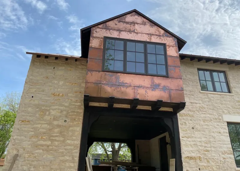 Copper metal panel facade on a stone building for Skylight Installation in Longview