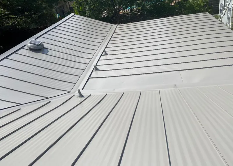 Solar attic fan installed on a metal roof for Roof Ventilation in Longview